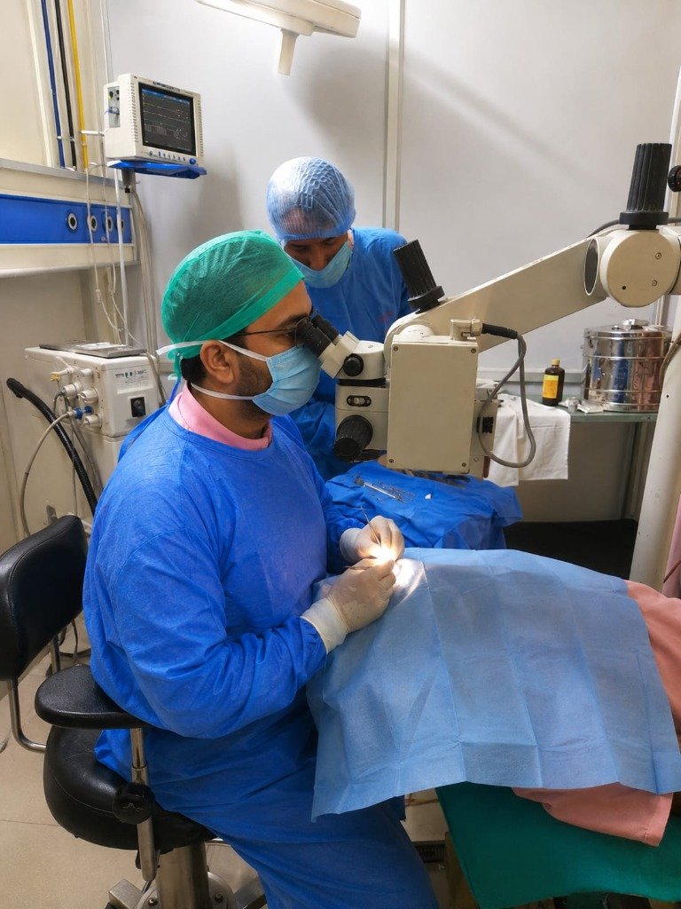 Eye Specialist Surgeon Performing Surgery Under Surgical Microscope